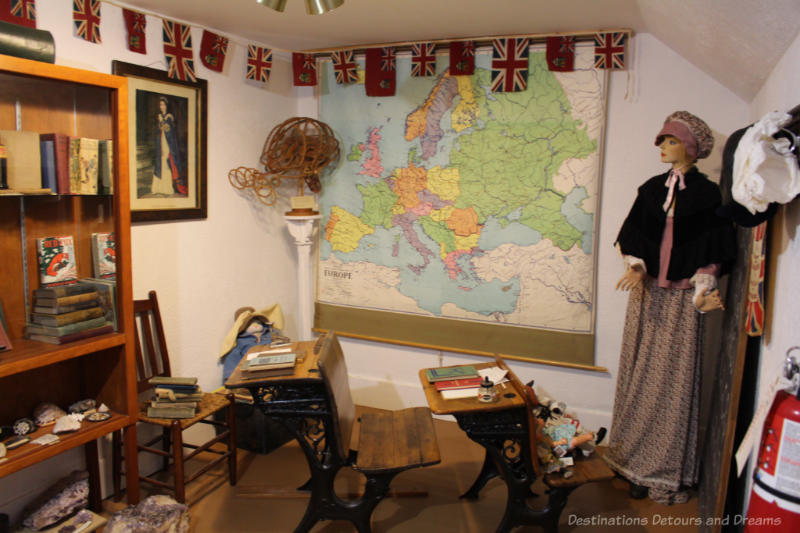 Old schoolroom display with wooden desks