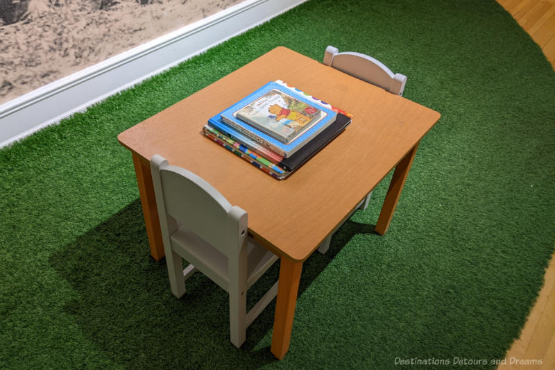 Child's table with two chairs and Winnie-the-Pooh books on the table