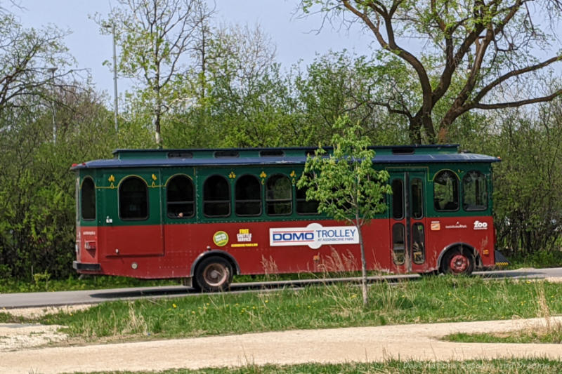 Trolley style bus running through park