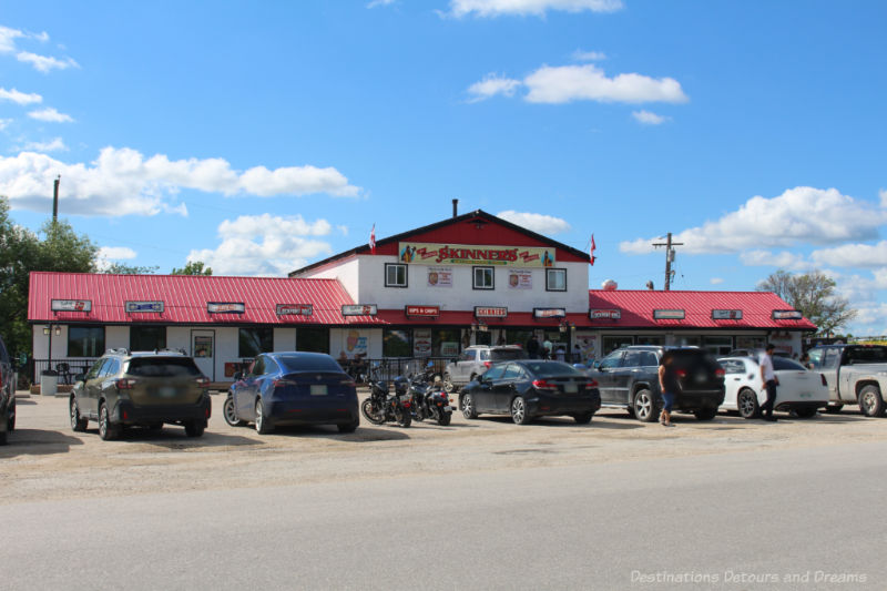 Outside of a hot dog and burger restaurant with red roof