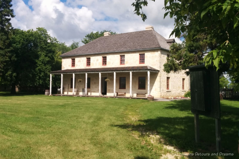 Two-storey 1850s stone house with covered front porch that served as a rectory