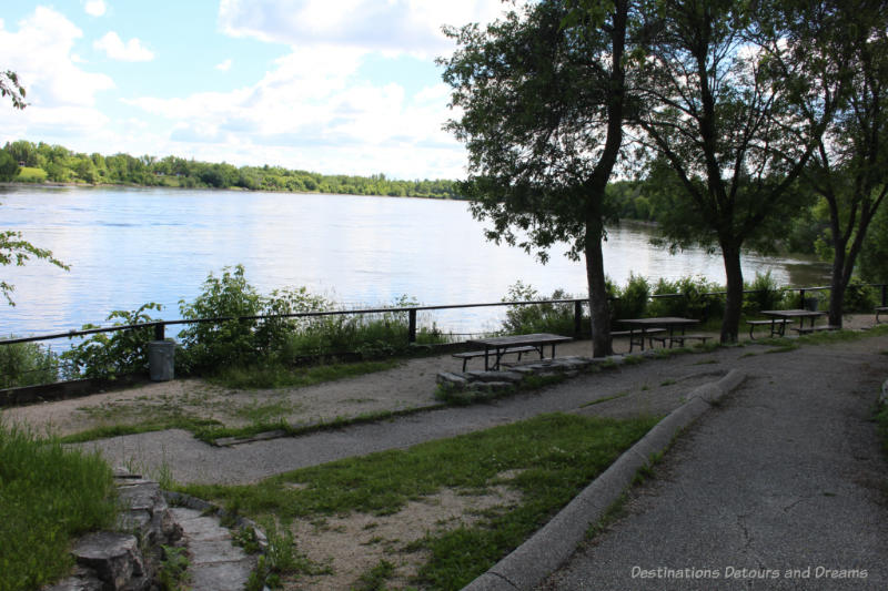 Picnic tables at a small park-like area overlooking a river