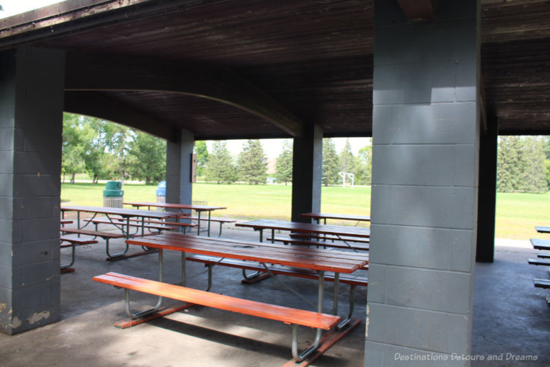 Picnic benches underneath a roofed shelter