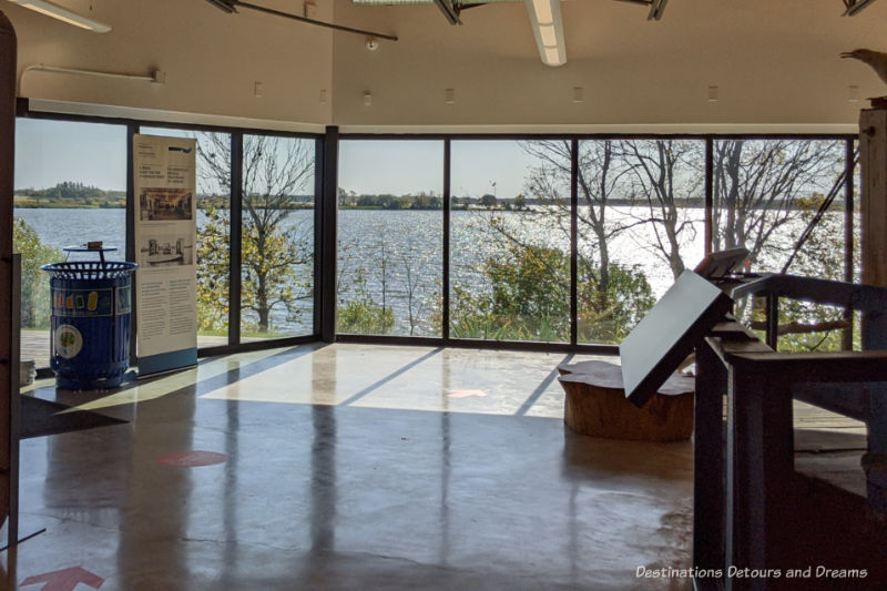 Area of museum with wall of windows providing a river view