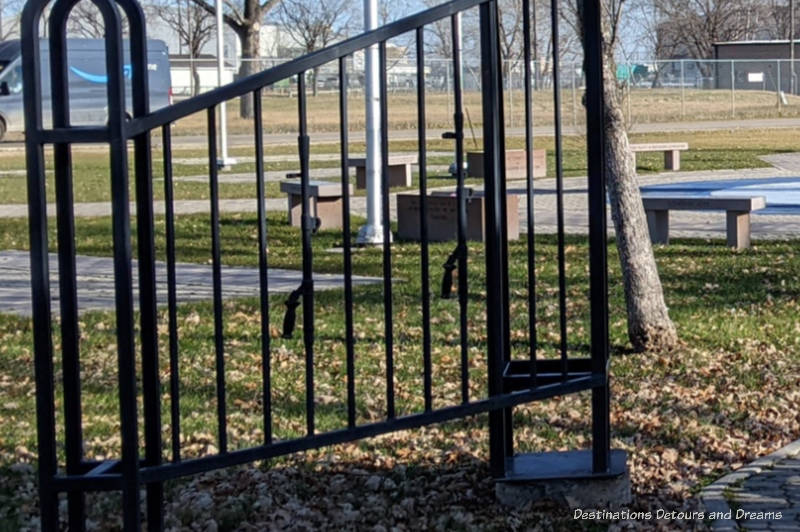 Close up of black metal fence showing gun handles built in