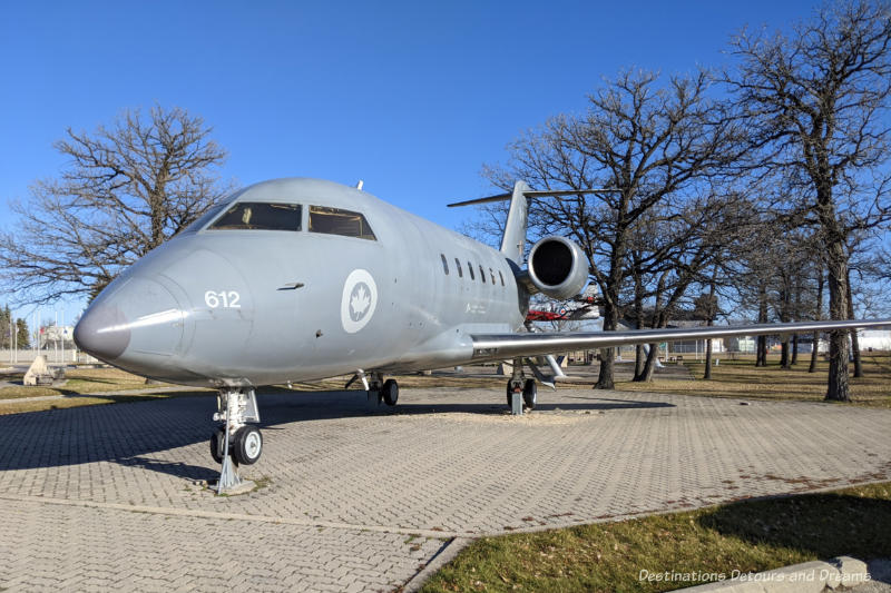 CX-144 Challenger plane on display siting on a pad of concrete bricks in an air park