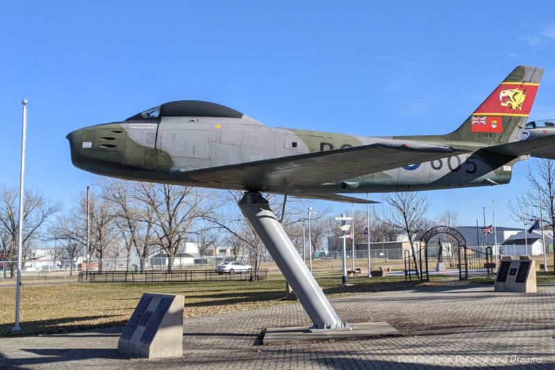 F-86 Sabre MK V! aircraft mounted on a pillar and on display in an outdoor park