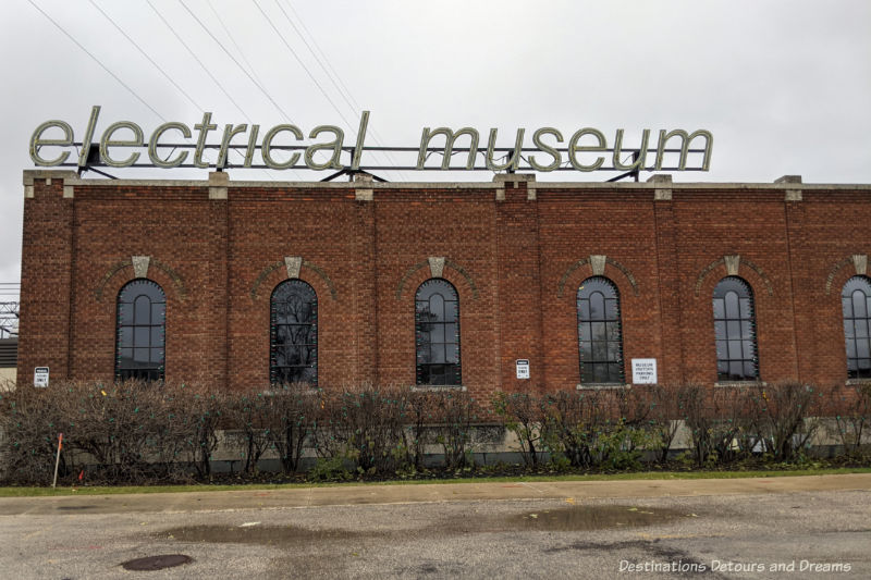 Brick building with lighted sign on top saying electrical museum