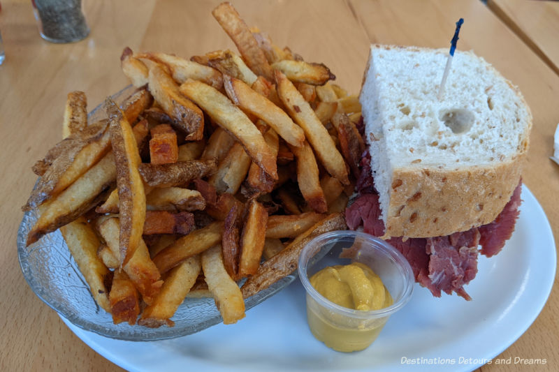 Half a corned beef sandwich with fries